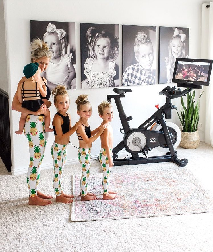 Mother taking picture with her four children all wearing pinapple leggings