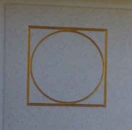 The Circle represents perfection and the eternal - the spiritual, the flame the soul - FIRE. The Square represents the mortal and carnal container - the box - the house - the Body. The circle inside the square is symbolic of the unity of Spirit Body and Mortal Body.