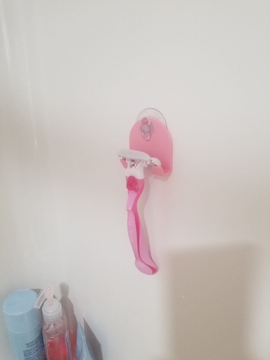 DeuxAlison's tweet photo. This morning I asked @ThierryDeux to design me something to hold my razor in the shower. This is what he came up with and printed it right away. Works pretty slick, just what I was looking for. Now how do I get him to do all the other projects around the house I ask him to do?? https://t.co/aHeG6Nikud