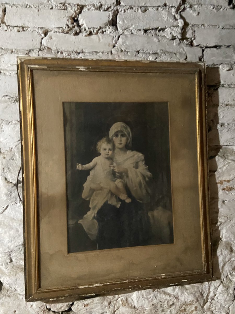 When I first saw the basement, there was this one room that was particularly strange. It was set up like a chapel, except that the pews were bails of hay. And on the wall was this framed picture.