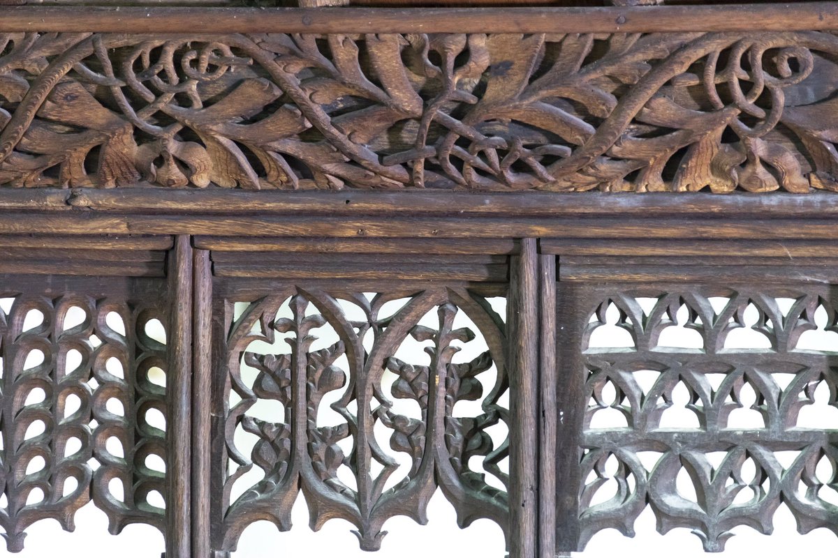 The thirty-four coving panels are decorated with seventeen different designs, creating a restlessness. The tracery heads hang like lace. The loft carries a line of twenty-five canopied niches.The carving is the work of the Newtown School of Carvers, Montgomeryshire.(3/7)
