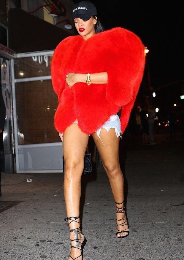 Rihanna gives her own fair share of influence in fashion and beauty through her career (she still DOES). Whether starting trends on outfits, make up looks, hairstyles and even tattoos. Rih walking around NYC in $15,000 YSL Heart Fur Coat and dsquared2 "Riri" sandals.