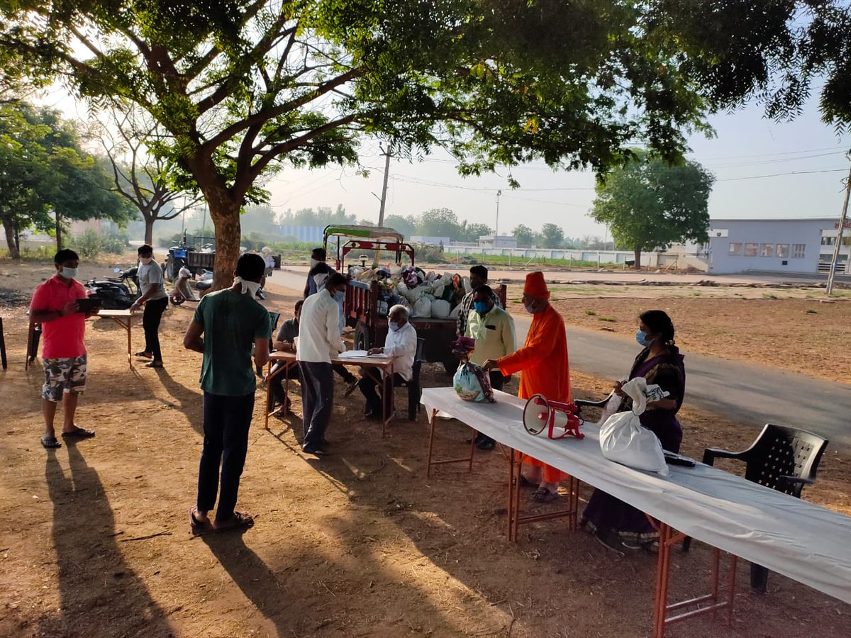 Swami Sachidanand distributes relief with a unique social distancing approach