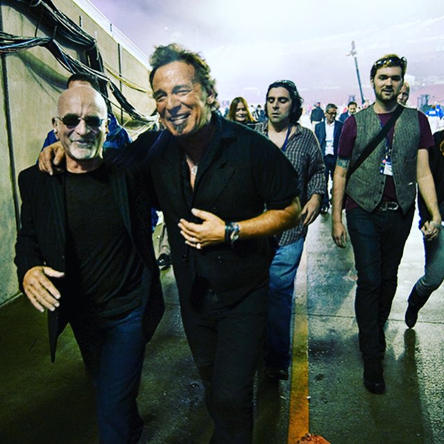 Danny_Clinch's tweet photo. Bruce ,Roy leaving stage after performing halftime show at the Superbowl ! They’re laughing at the “referee” that slipped and fell on his ass during their rain soaked performance . They were like little kids that can’t stop laughing when mom tells you to be quiet ! #DCPHOTOSOFJOY https://t.co/m2CrYyj9DI
