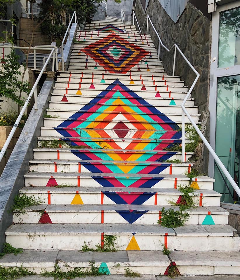 Trippy Tehran, part two.These stairs are painted with Esfand Bafi, a charm common in Iran to protect from the evil eye, similar to nazar.Esfand bafi refers to the dried seeds hanging from the charms. Esfand is commonly burned in Iran as a holy incense for protection.