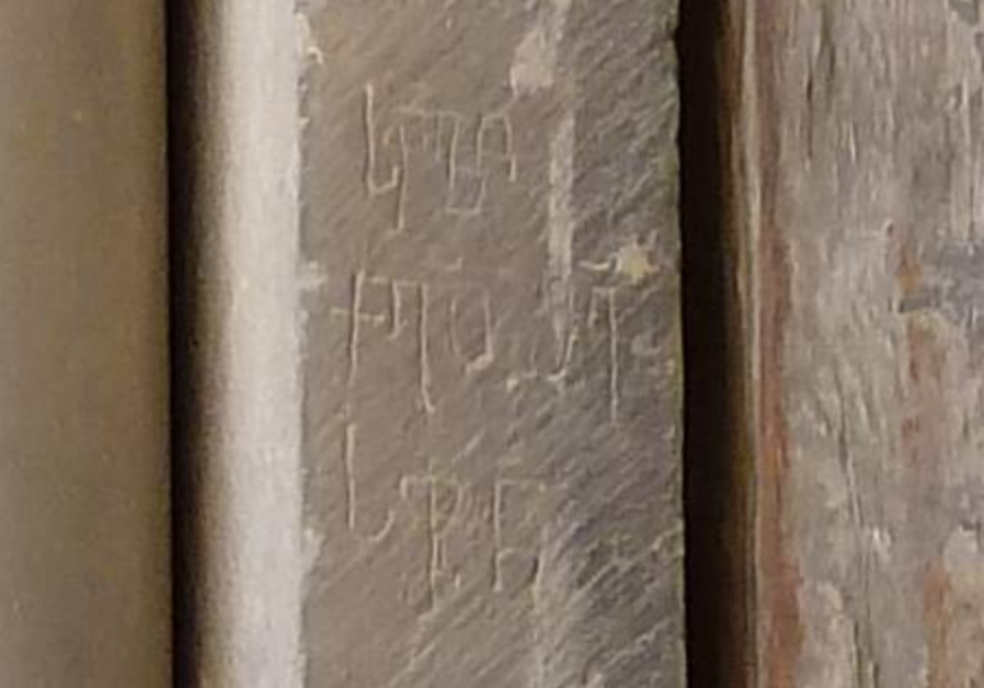 On the wall between the door and the closest column, an inscription in Georgian: "The tomb of Christ, have mercy on Sopron"(detail of photo by Djampa) https://commons.wikimedia.org/wiki/File:Old_Jerusalem_Holy_Sepulchre_gate_and_columns.jpg