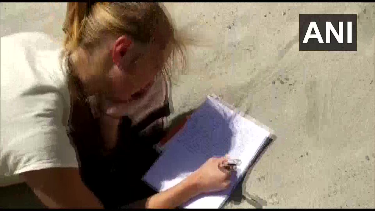 ANI's tweet photo. Uttarakhand: 10 foreign nationals who were caught strolling along the bank of river Ganga in Rishikesh were made to write "I didn't follow lockdown rules, I am sorry', for 500 times as a punishment for violating #CoronavirusLockdown. (12-4-2020) https://t.co/vd3BJeoHm0
