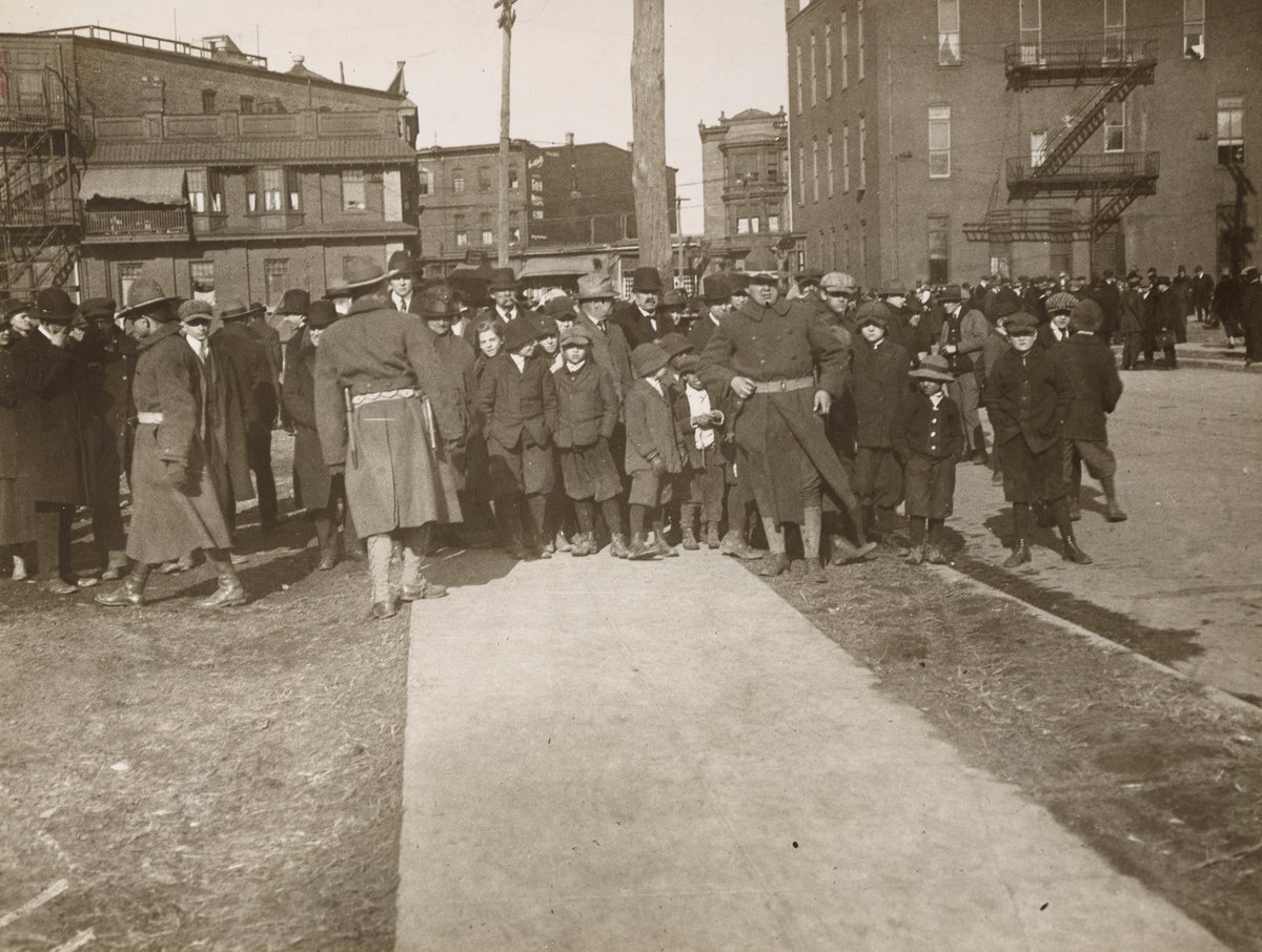 Guards keeping back people that swarmed around the plant to find out whether their loved ones were injured, alive, or dead:  https://catalog.archives.gov/id/31478191 