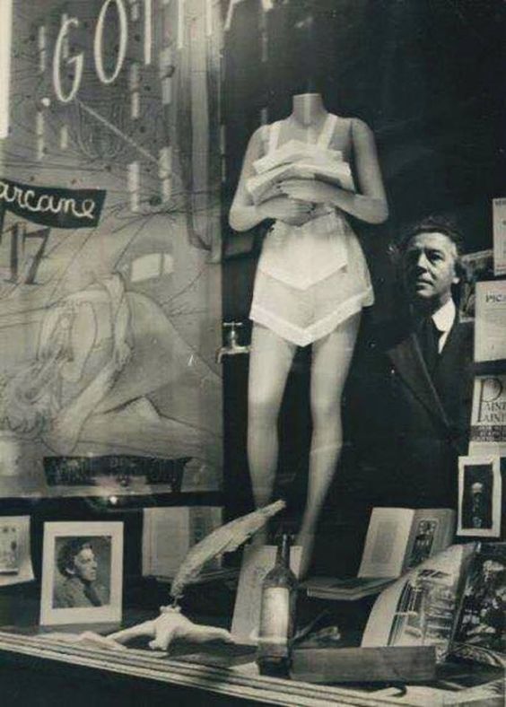 Marcel Duchamp’s window display (the mannequin is his 'Lazy Existence') at the Gotham Book Mart, NYC for André Breton’s 'Arcane 17' in 1944. Maya Deren took the photograph, capturing Breton himself reflected in the window.
