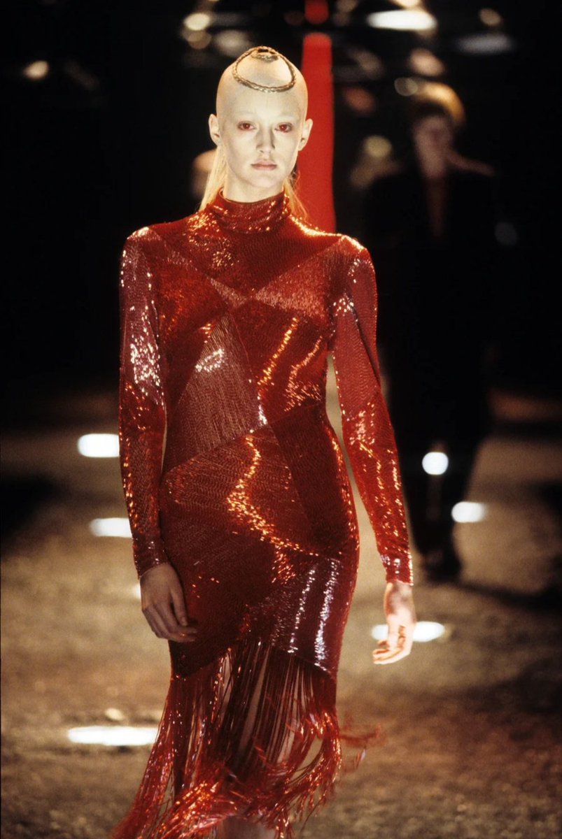 Fall Winter 1998:"Joan"Cette collection s'appelle comme ça en référence au meurtre de Jeanne d'Arc duquel il s'inspire. On retrouve des coiffures circulaires médiévales et une femme entourée de flammes, comme un bûcher, a la fin du défilé