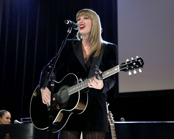 taylor swift with a guitar; a necessary thread