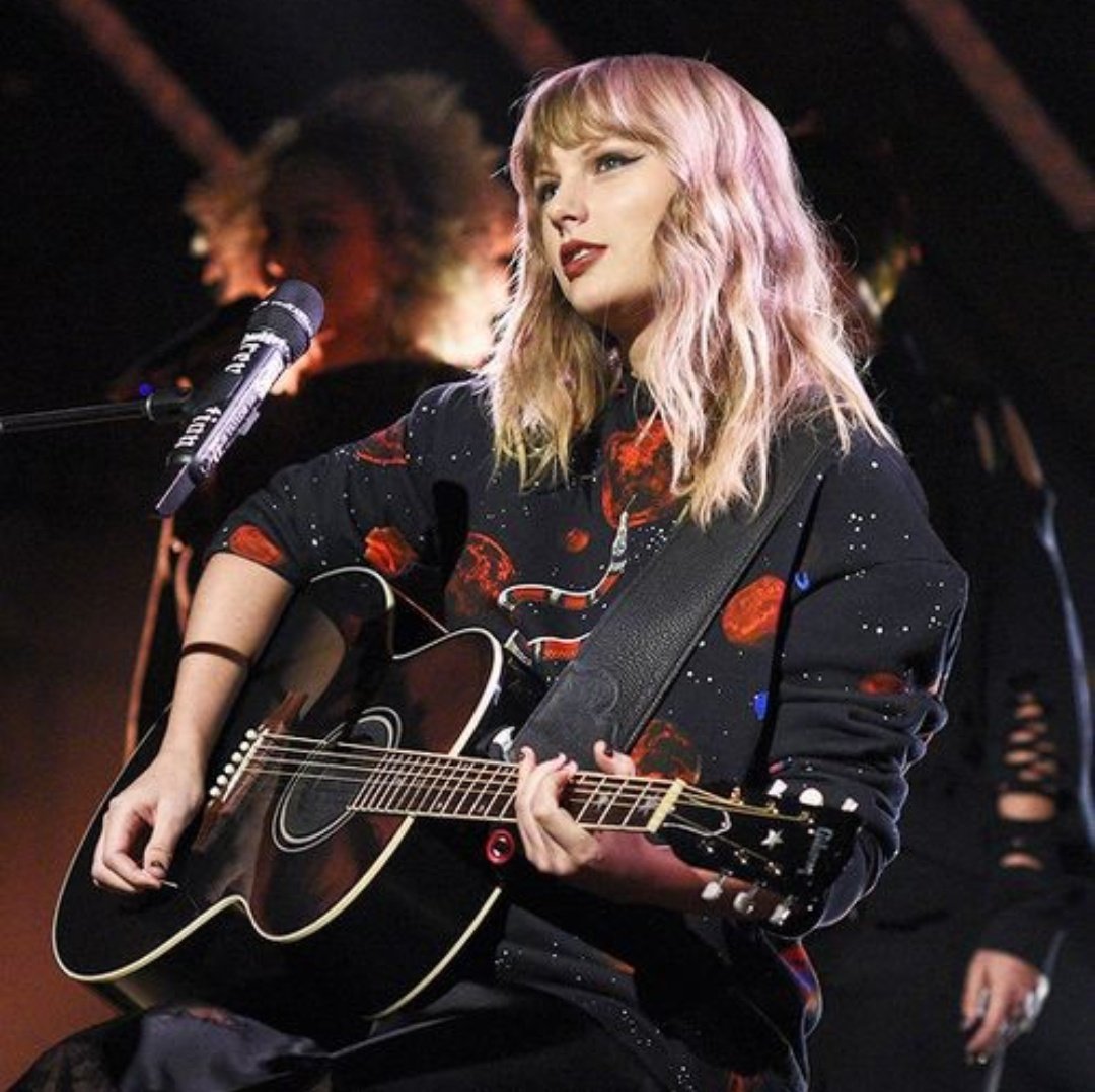 taylor swift with a guitar; a necessary thread