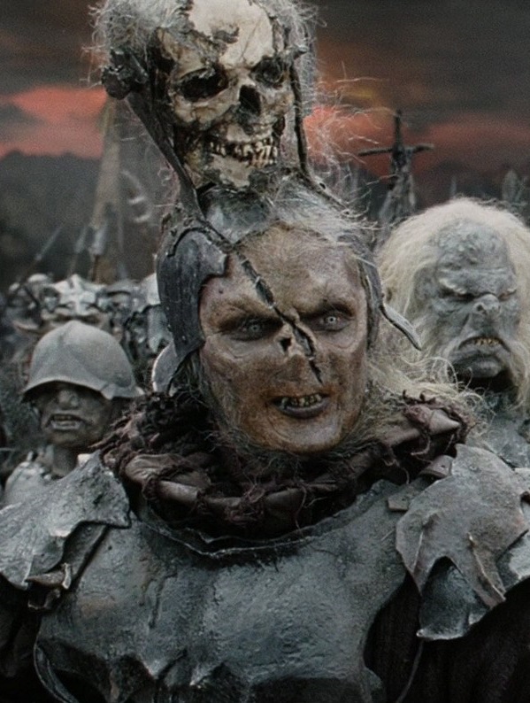 Honorable mention to the "late, as usual" Return of the King orc who wears a skull on top of his head for some reason. In an audio commentary, Jackson & Walsh suggest that it's his mom's head he wears. Jackson's horror-comedy roots really come out in the LOTR orc designs.