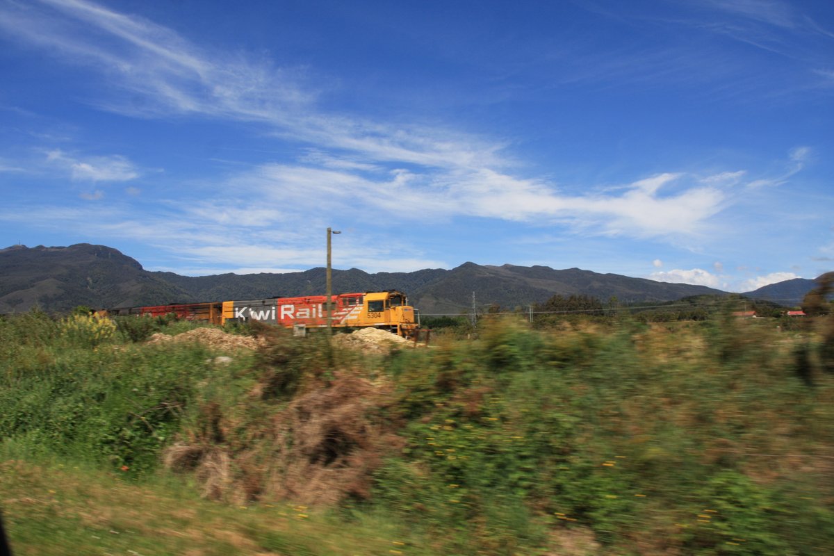 A real train! Quick, where's the camera! A frantic snap from the car of DX-class engines 5304 and 5477 pulling a coal train south between Ngākawau and Granity.