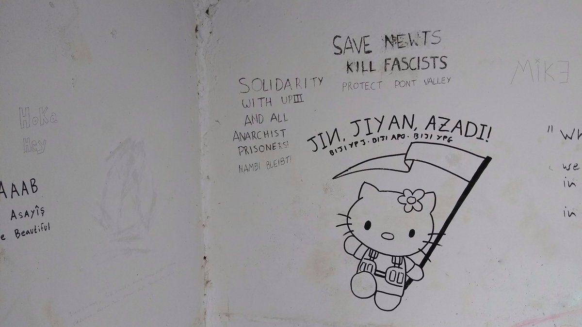 SabCharlie's tweet image. I recently found some graffiti I did last time I was here in #Rojava, two and a half years ago! The Hello Kitty is mine, I suspect the Newt bit was Waka (Şehîd Şahîn Qereçox), and the UPIII one could be any of the Hambis who've fought here.