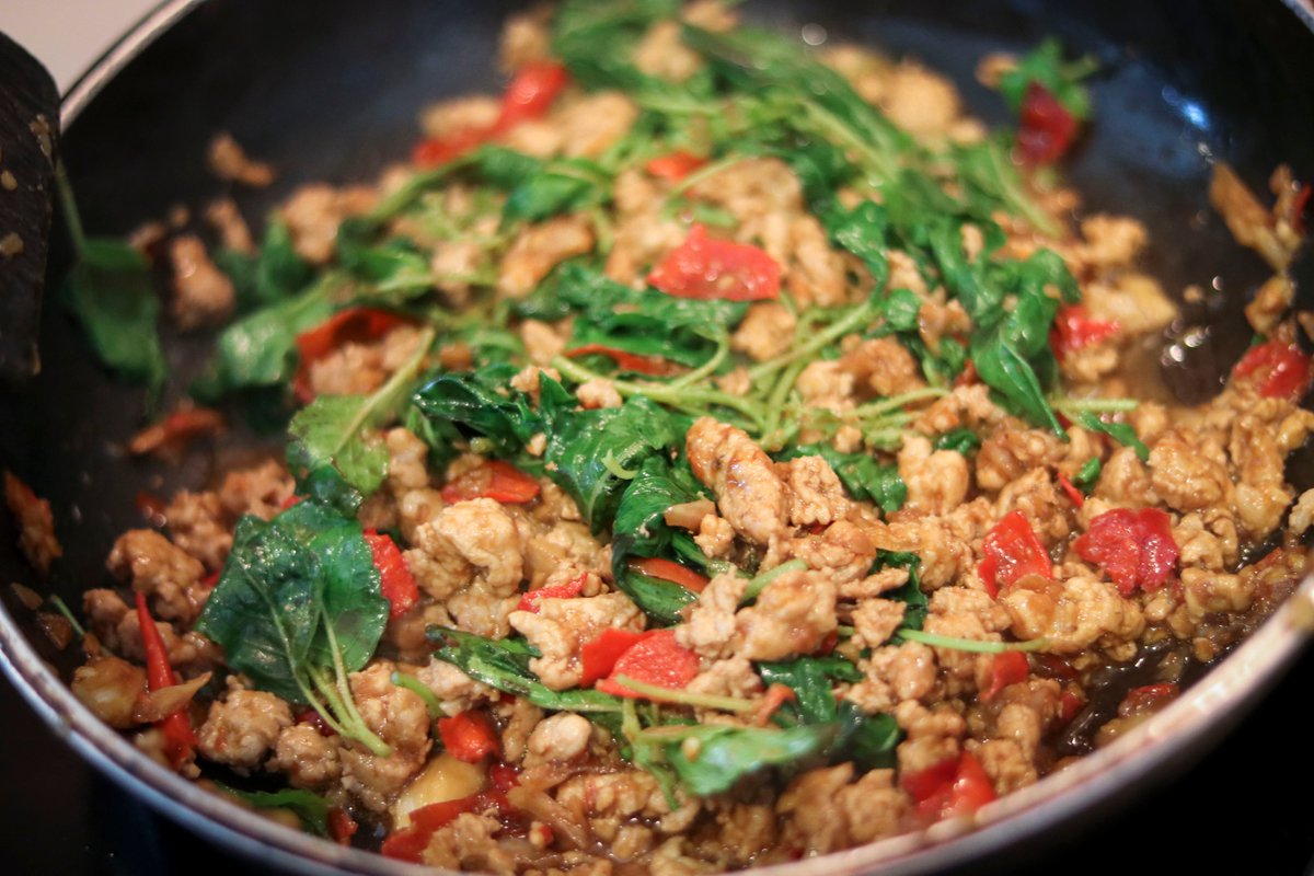 Add the holy basil, stir, wait until everything is cooked and serve next to rice.