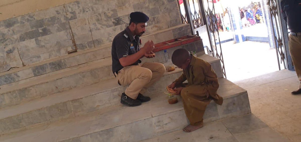 A police constable sharing his food with a poor child ! Such policemen are most respectable human beings