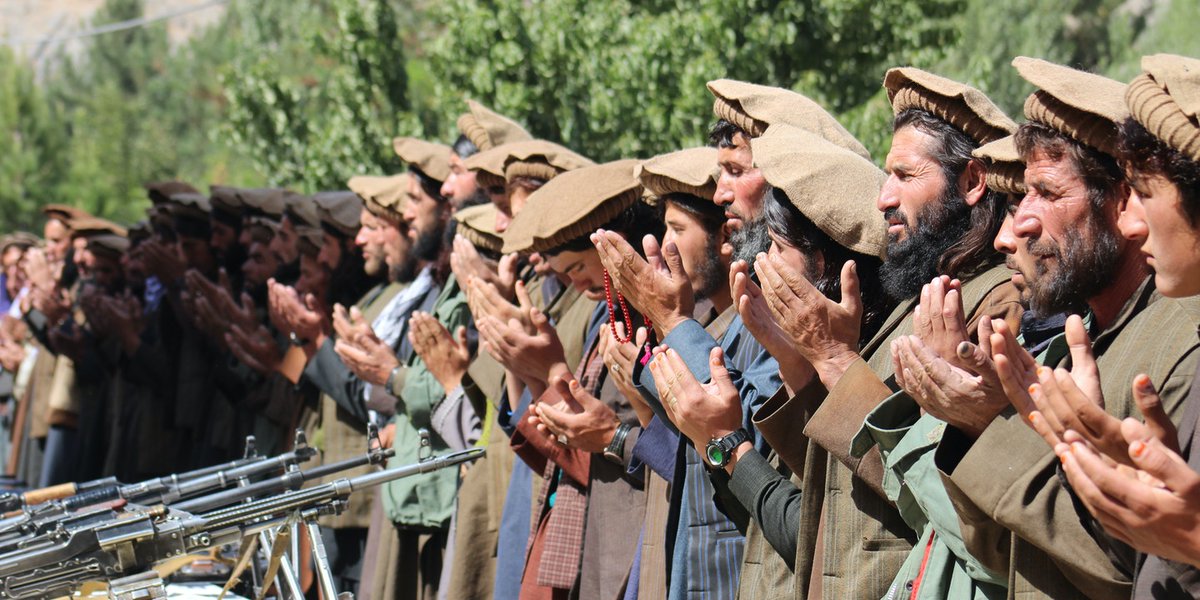 People of Badakhshan: A group of Tajik Taliban praying after dropping their weapons and joining the Afghan government. Photo: Mohammad Sharif Shayeq.