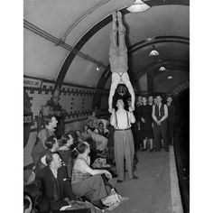 and what about these people sheltering in the Blitz? Apparently they're so "overwhelmed" they've got time for a concert.... and even photos of handstands!
