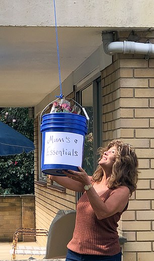 Jamess12316's tweet photo. A daughter has resourcefully found a way to get supplies to her elderly mother while still keeping social distance with a bucket tied to a rope. https://t.co/9gKwHxpEGv