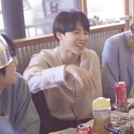 jimin with his one leg up on the chair