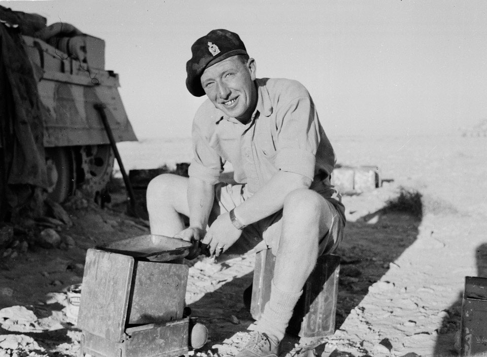 Soldier from 3 CLY making a brew in North Africa. IWM image.