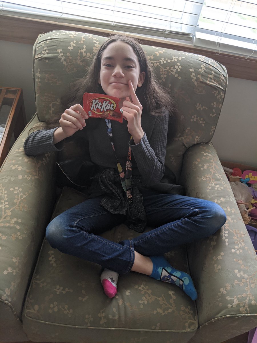 Killing two birds with one stone...mismatched socks and favorite snack!  She’s sad because it’s her last Kit Kat bar.  Spirit week continues...