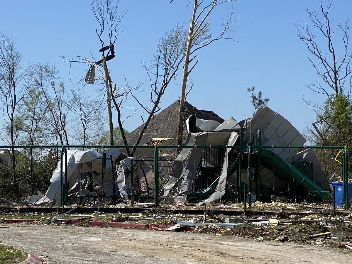 The playground at the school is hardly recognizable. It appears pieces of the roof are now draped over the slide. Devastating...