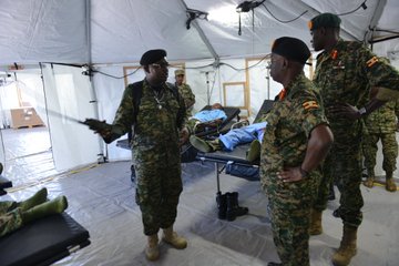 JINJA, Uganda--1st Lt. Vincent Nzayisenga, medical clinic officer, Uganda People’s Defence Force, gives directives to UPDF soldiers about the layout of a UN-standard level-2 mobile treatment facility, May 15, 2019, during the vendor training event at the URDCC motor pool, Jinja, Uganda. (Photo by U.S. Army Staff Sgt. Grady Jones, Public Affairs, U.S. AFRICOM) 
