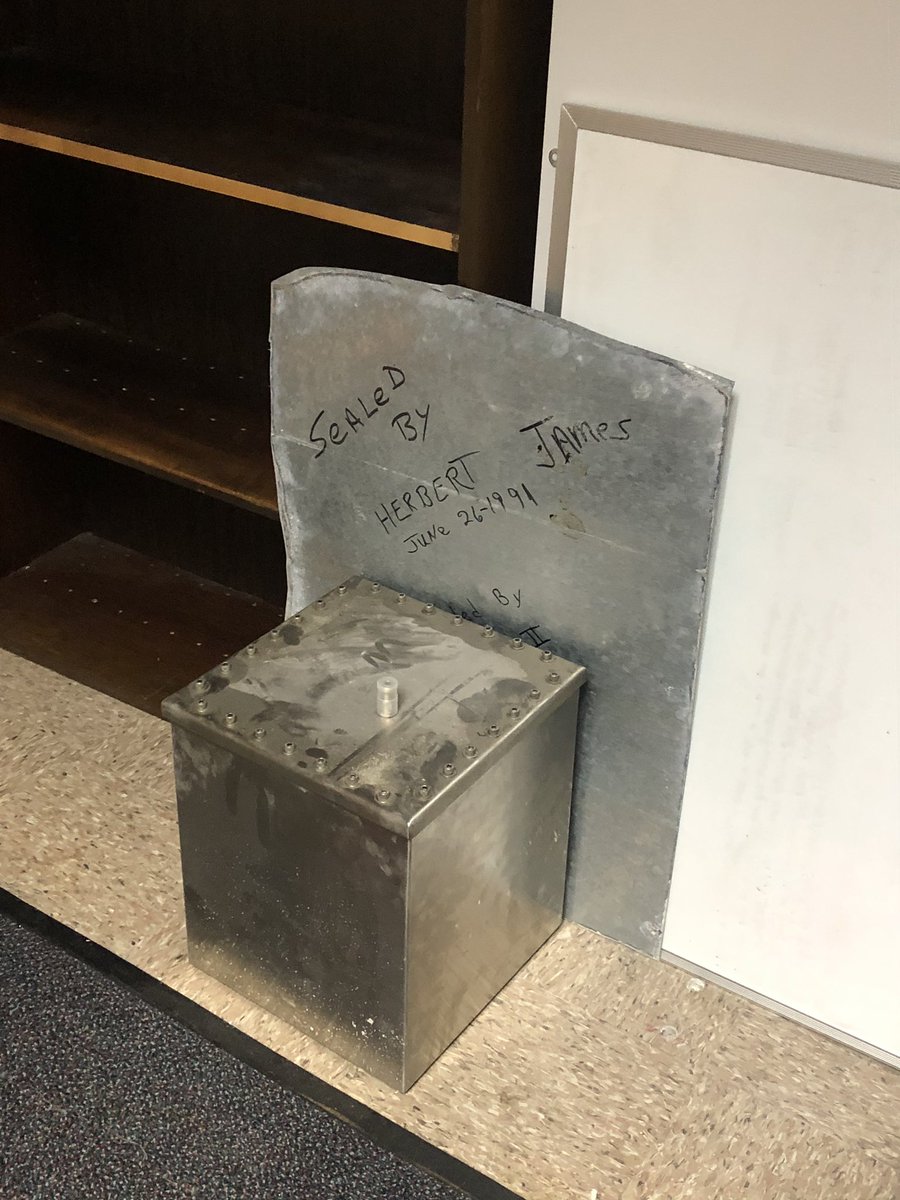 This is a time capsule from 1990.  @JakonHays pulled it out of a wall on the first floor. It's due to be opened in 2065.