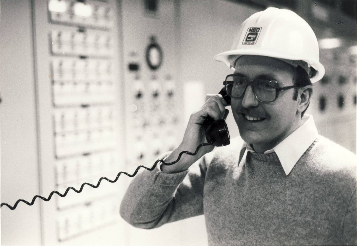 our late-80s-era caps featured the NEO lettermark, logo, and full name imprint. some of these caps remain in circulation today.actually the guy in the pic remains in circulation too. he's bob bonnett, superintendent of our Easterly plant even today.