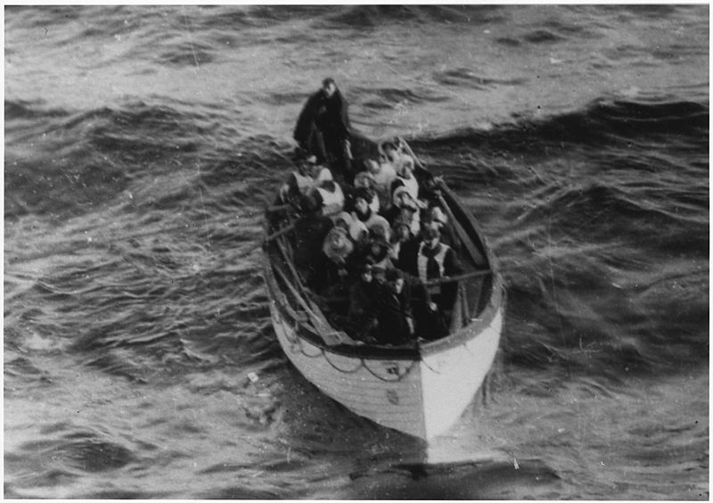 This is a photograph of a lifeboat carrying survivors. "Boat No 6, 16, 11 women, 6 men, Miss Bowerman, Mrs. J. J. Brown, Mrs. Candee, Mrs. Cavendish, Mrs. Cavendish (Maid), Mrs. Meyer, Miss Norton, Mrs. Rothchild, Mrs. L. P. Smith, Mrs. Stine & Maid, Hitching Q. M."