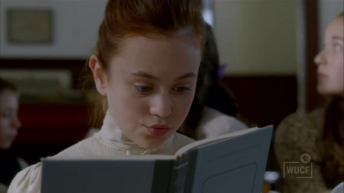 Anne is reading a romance novel in class while Miss Stacey is explaining geometry (good thing she's good at geometry right? WRONG). Miss Stacey sees her because she's not subtle at all.