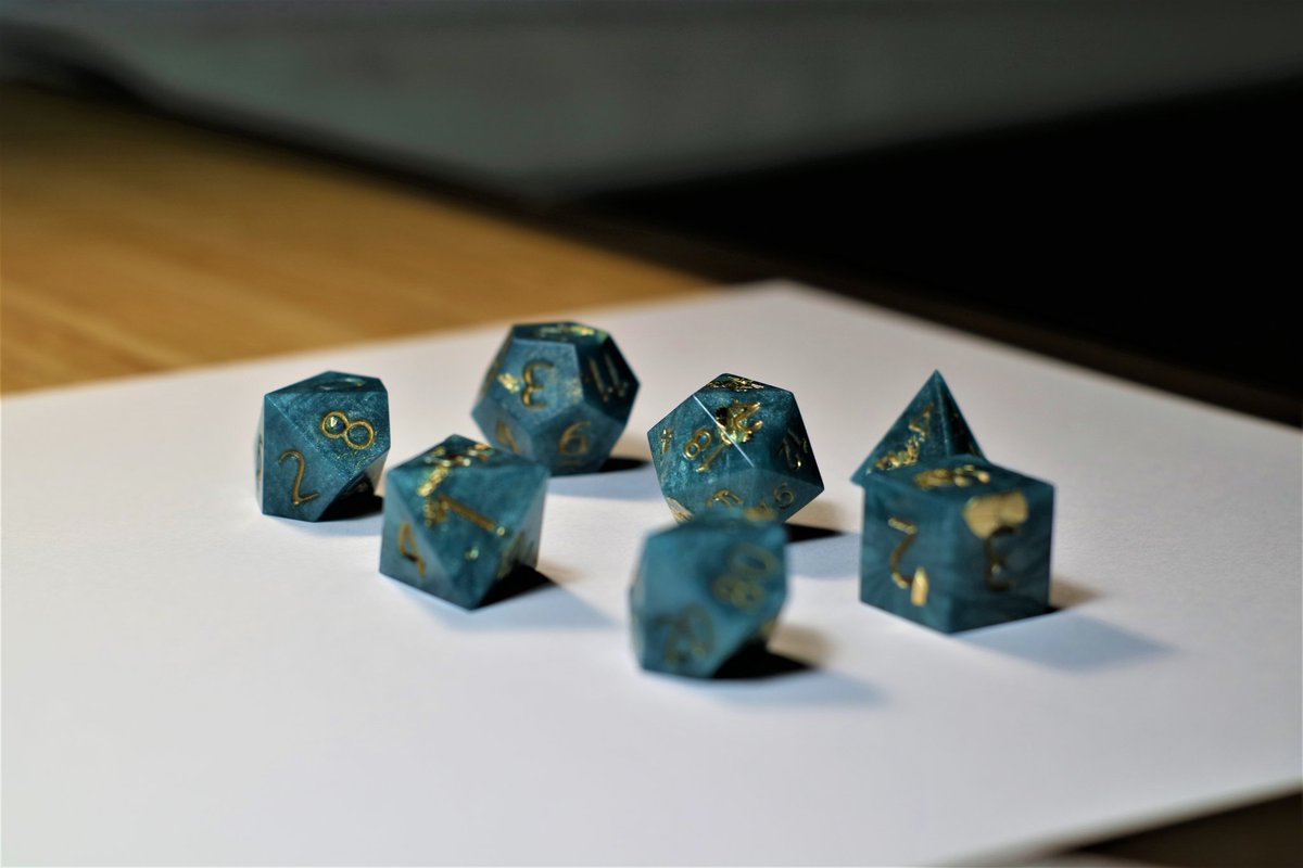 Daikondice's tweet photo. A swirling current of emerald and gold adorned with gold flakes that balance on the sharp edges.
My first set! Pictures really don't do them justice :)
#dice #dnd #dnd5e #diceporn #resinart #resin #handmadedice #dicemaking #sharpdice https://t.co/47qxddCce0