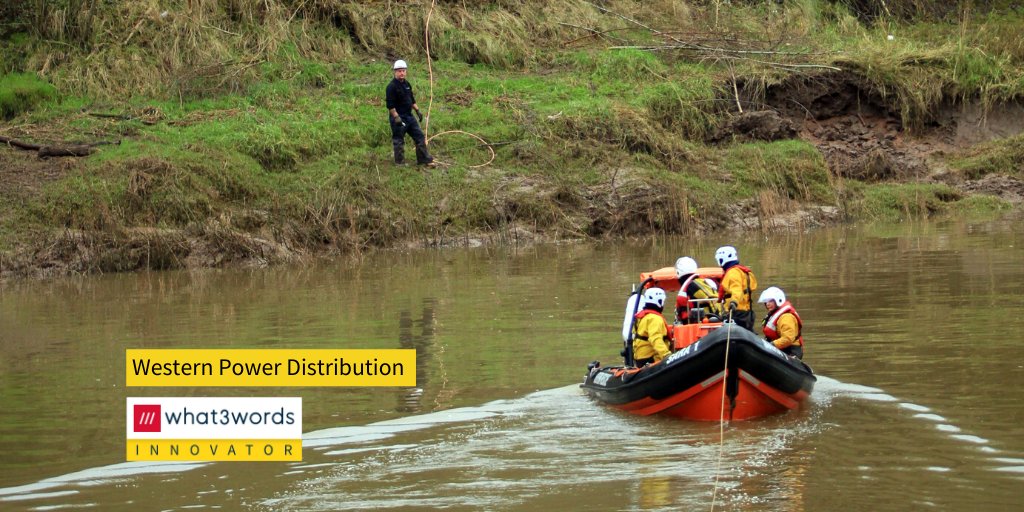 western power distribution worker by a river. rescue boat approaching.