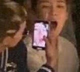 mino taking a picture of seunghoon's uvula during a chanel fashion show