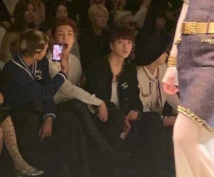 mino taking a picture of seunghoon's uvula during a chanel fashion show