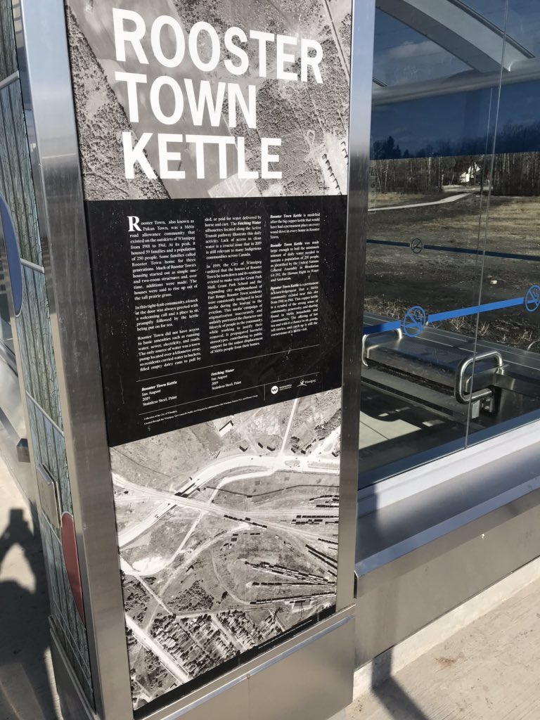 Continuing with photos of new BLUE rapid transit line stations and the public art...Here's the same photo again of the Rooster Town Kettle I like so much, along with photos of the plaque describing it, and a photo of the art showing a Métis child bringing water home on a sled.