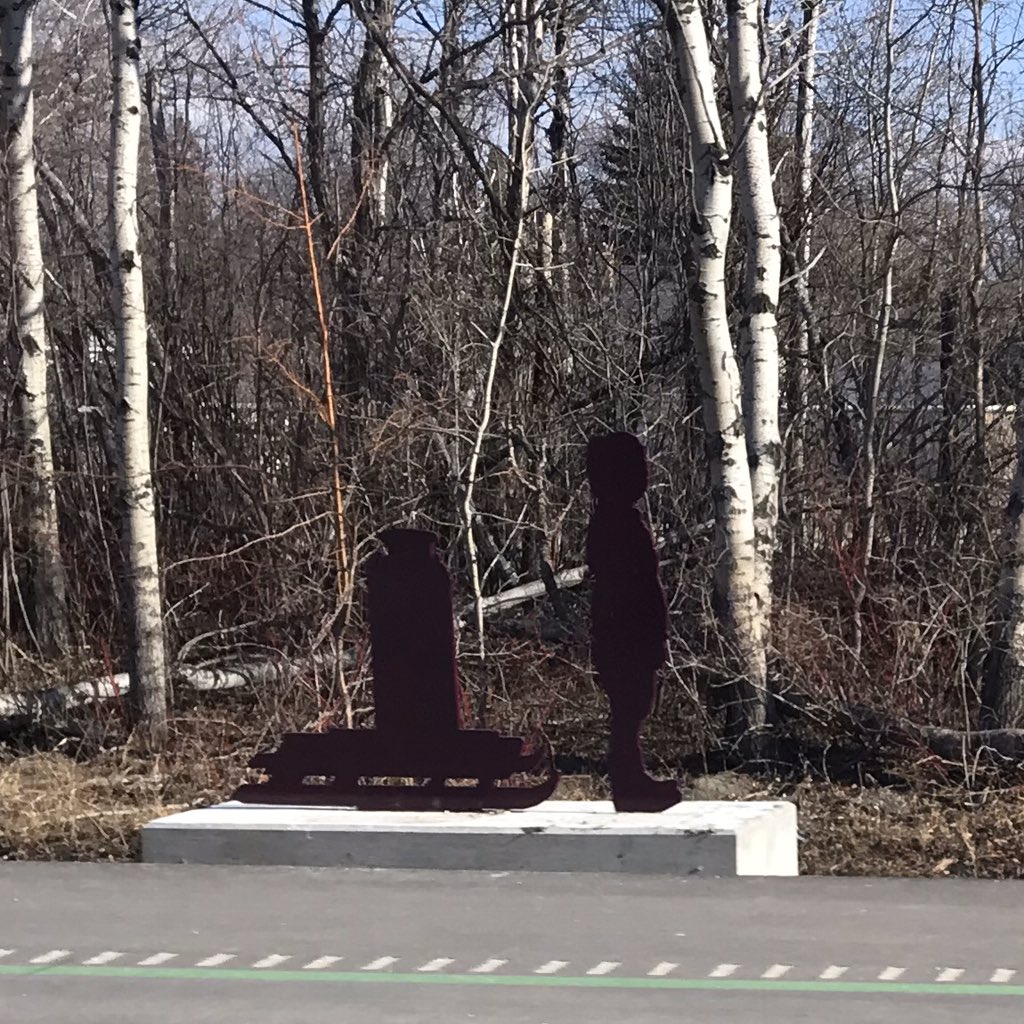 Continuing with photos of new BLUE rapid transit line stations and the public art...Here's the same photo again of the Rooster Town Kettle I like so much, along with photos of the plaque describing it, and a photo of the art showing a Métis child bringing water home on a sled.