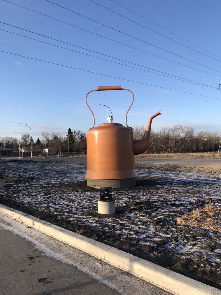 Continuing with photos of new BLUE rapid transit line stations and the public art...Here's the same photo again of the Rooster Town Kettle I like so much, along with photos of the plaque describing it, and a photo of the art showing a Métis child bringing water home on a sled.
