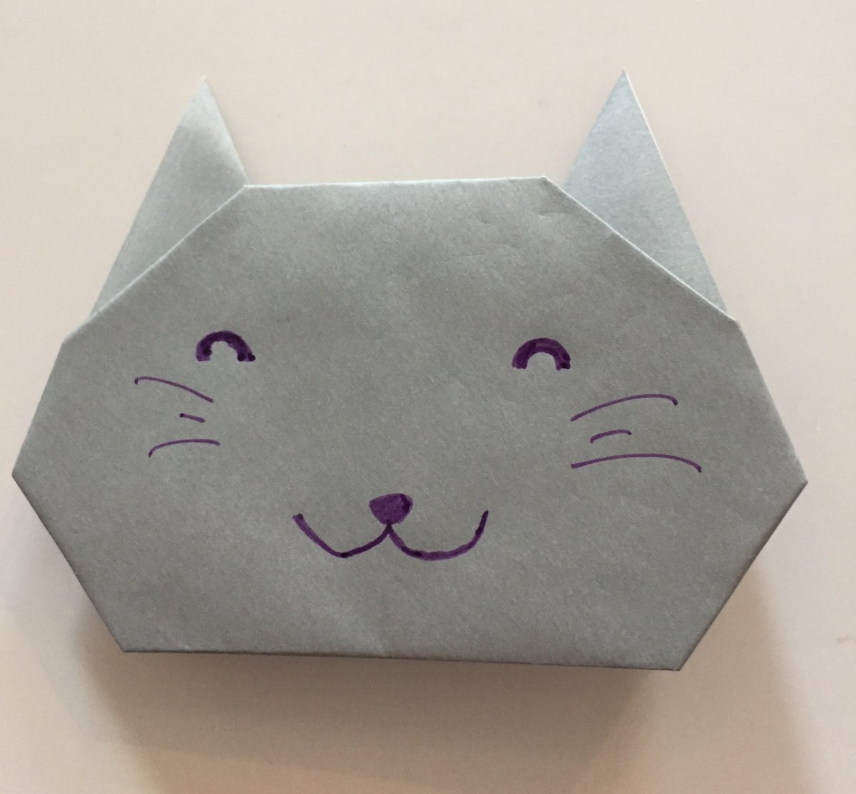 6. I used 15 cm x 15 cm  #origami paper for this Easy Origami Cat. If you want to attach this cat to a card or drawing, you may want to glue or tape the back. But the bottom 2 folds can also act as a stand.