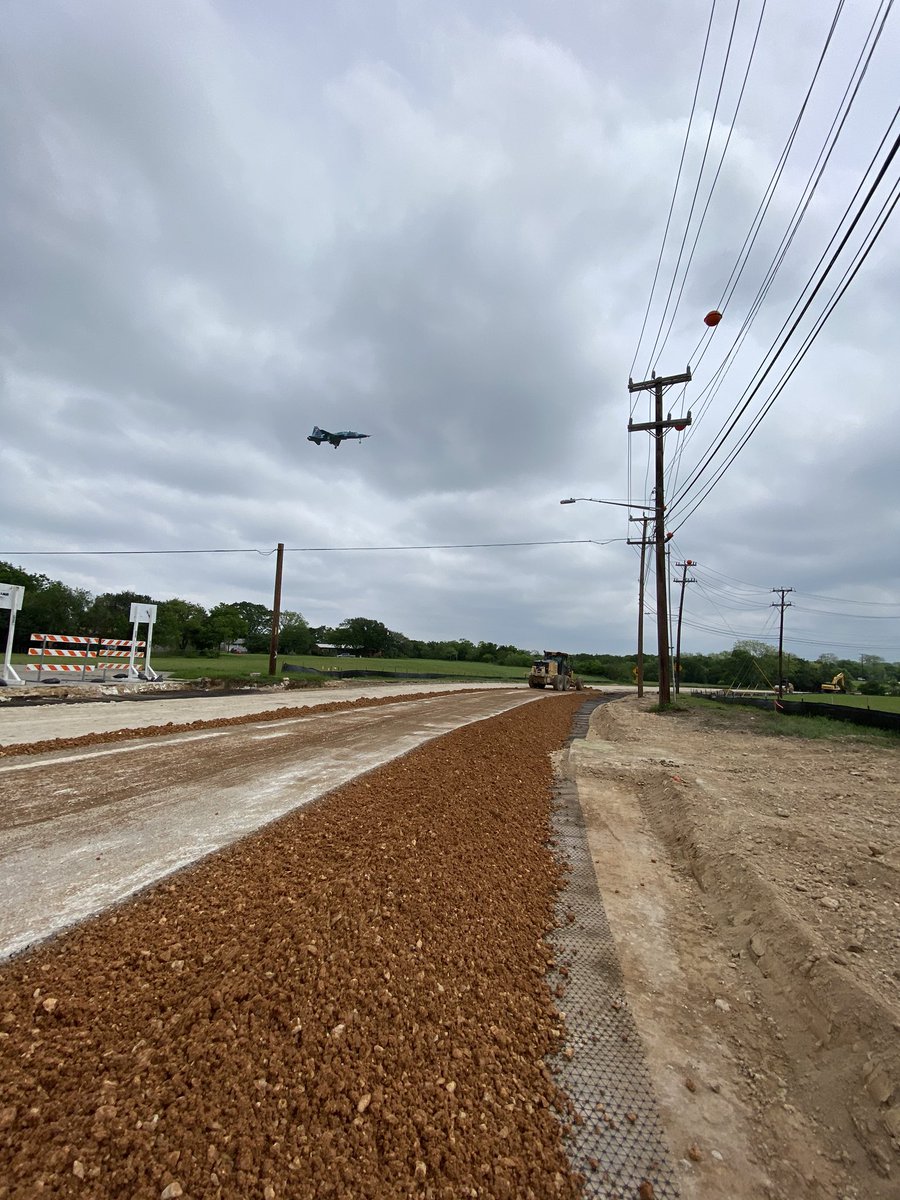 Our blade man demonstrates his talents and many years of experience by mixing the base on the asphalt and then evenly distributing the material across the narrowly excavated section on this portion of this large street reconstruction process.