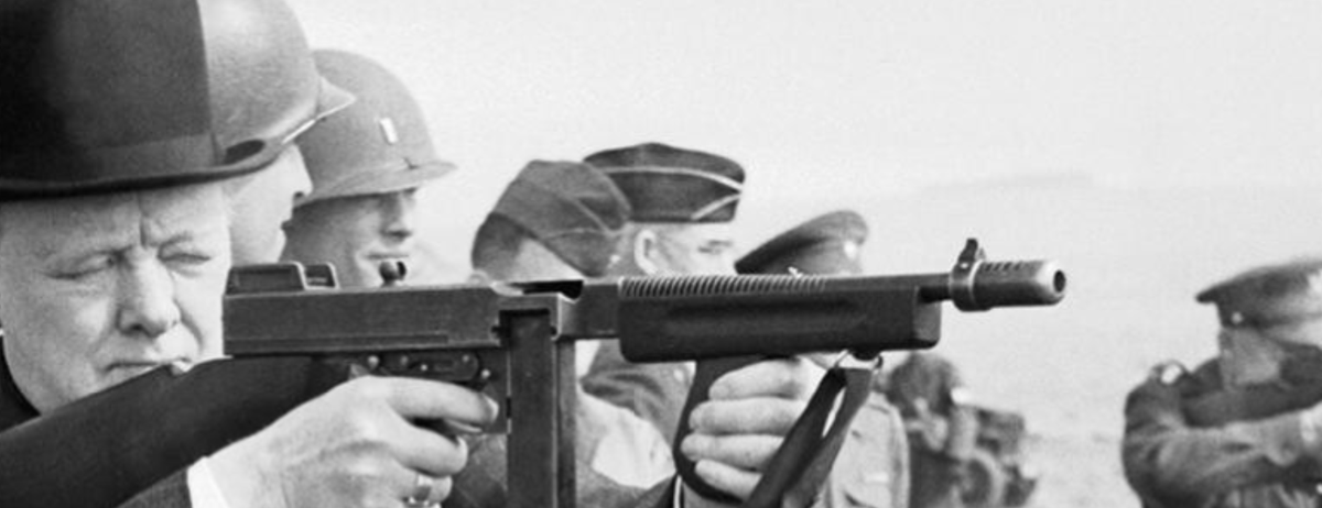 Looking at higher res version, I noticed two details. The first is for fellow firearms nerds - Churchill is shooting an M1928, but it's been modified with a non-standard foregrip - M1 style, but with pistol grip also. Perhaps a US officer's personal weapon, modified to his taste.