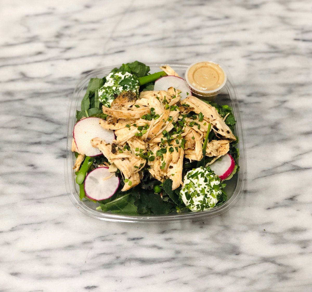 We're bringing #spring indoors with this succulent salad 🥗 With pulled herbed roasted chicken, herbed goat cheese, asparagus, peas, radishes, and toasted almonds, this dish is dressed in a mustard vinaigrette and served on a bed of greens. 

#eatPALETA ➡️ paleta.com/eat.php