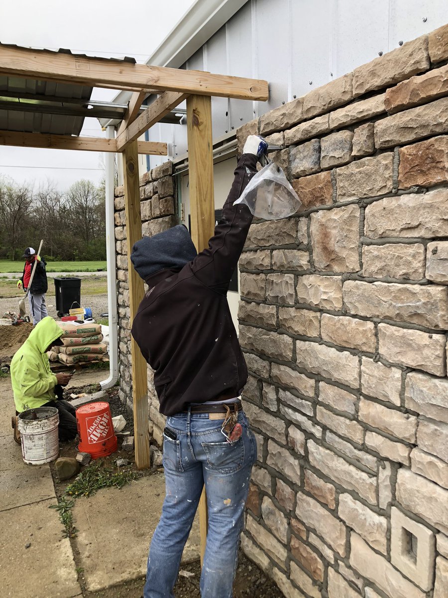 Work has resumed on the stone front of the post. Looking good.