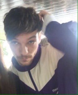 Louis Tomlinson fixing his fringe; a thread