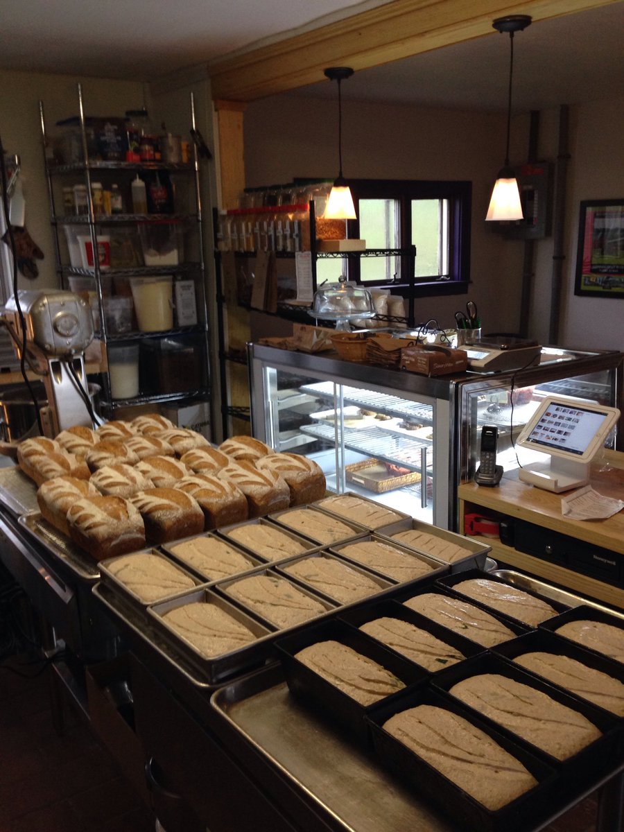 Upinngil's tweet photo. Early morning in the new Little Red Hen bakery. Wheat n Rye sourdough just out of the oven and Wild ramp and cheese about to go in. Finally getting the hang of this new oven! https://t.co/mB4YbHb6Do