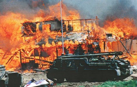 • The tanks move in & flatten all the compound outbuildings/a gravesite• They punch holes in the compound walls & pour in tons of the gas.• Nobody comes out.• Suddenly, fires break out in three different corners of the compound.• CS gas is extremely flammable, remember?