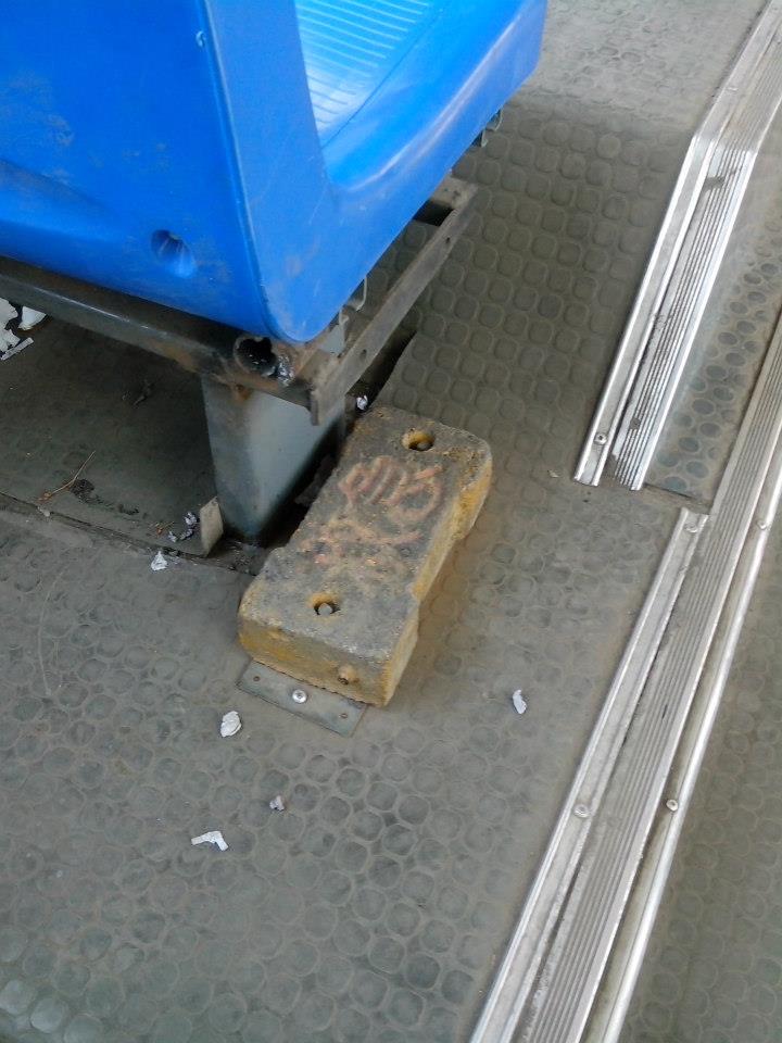 China pic, day 11:"Emergency Brick" on the floor of the 707 bus in Xi'an. The characters on it are 救急, roughly meaning "use in emergency." It was the local version of the little glass-breaking hammers, held to the ground by two pegs. Gotta love the practicality.