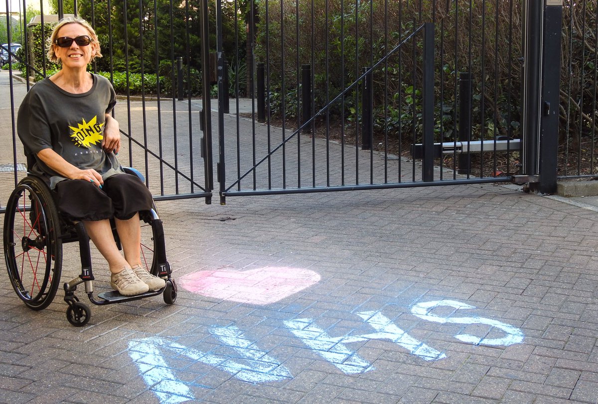 Mandi asked me to come and take her picture and when she came to her gate we found this  #ThankYouNHS chalk. Ellen did a jump for her portrait. Not to be outdone, Mandi pulled a wheelie. #LoveInATimeOfIsolation #LoveInATimeOfCorona #DoorstepPortraits  https://www.instagram.com/p/B_MRDK4nOMV/?igshid=v4losma0nifw